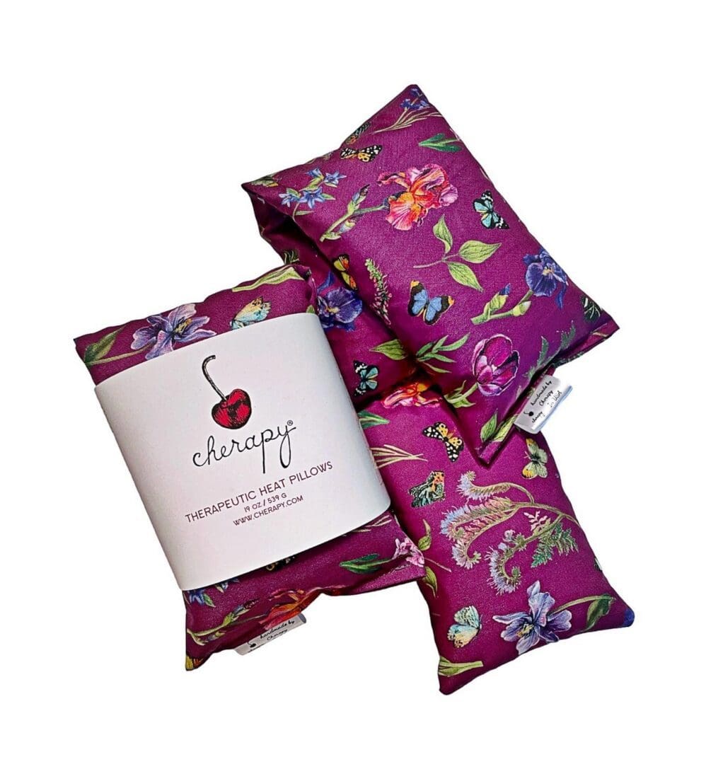 Set of three pink therapeutic heat pillows with a floral and butterfly design, branded as "CHERAPY Wrap Pillow 100 Percent (REGULAR) Cotton – in the Spring Flower Butterfly Design.
